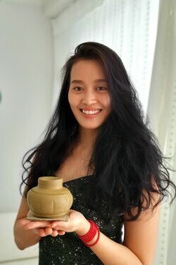 Mai Phuong with her handmade pottery vase in Thailand